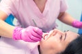 Female dentist curing a woman patient. Dental clinic and dentist appointment concept Royalty Free Stock Photo