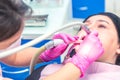 Female dentist curing a woman patient. Dental clinic and dentist appointment concept Royalty Free Stock Photo