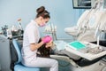 Female dentist with dental tools - mirror and probe checking up patient teeth at dental clinic office Royalty Free Stock Photo