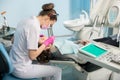 Female dentist with dental tools - mirror and probe checking up patient teeth at dental clinic office Royalty Free Stock Photo