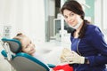 Female dentist doctor and little patient at office