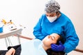 Female dentist doing an maxillofacial exam to a female patient