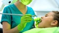 Female dentist drilling teenage girl tooth, caries removal, healthy oral cavity Royalty Free Stock Photo