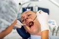 Female dentist examines the oral cavity of female patient. Dental treatment in dental clinic