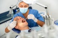 Female dentist examines the oral cavity of female patient. Dental treatment in dental clinic Royalty Free Stock Photo