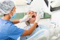 Female dentist examines the oral cavity of female patient. Dental treatment in dental clinic Royalty Free Stock Photo