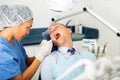 Female dentist examines the oral cavity of female patient. Dental treatment in dental clinic Royalty Free Stock Photo