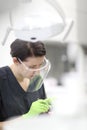 A female dentist examines the oral cavity of a patient