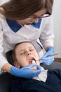 Female dentist examines the teeth of the patient child Royalty Free Stock Photo