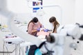 Closeup of a dentist and assistant treating a patient in dental clinic Royalty Free Stock Photo