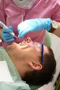 Female dentist examining patient teeth in dental clinic Royalty Free Stock Photo