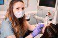 Female dentist examining patient teeth in dental clinic. Royalty Free Stock Photo