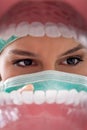 Female dentist examining teeth.