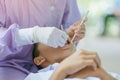 Female dentist examining teeth of a student with mouth mirror and probe checking