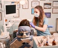 Female dentist examining woman teeth in dental office. Royalty Free Stock Photo