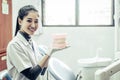 Female dentist explaining artificial teeth to patient in clinic Royalty Free Stock Photo