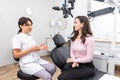 Female dentist explaining patient treatment during an appointment in dental clinic Royalty Free Stock Photo