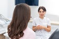 Female dentist explaining patient treatment during an appointment in dental clinic Royalty Free Stock Photo