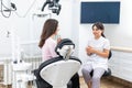 Female dentist explaining patient treatment during an appointment in dental clinic Royalty Free Stock Photo