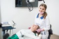 Female dentist with happy patient during dental procedure in the dental clinic. Dentistry. Stomatology equipment