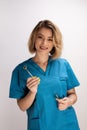 Female dentist holding a mirror and dental tools Royalty Free Stock Photo