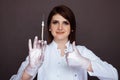 Female dentist holding syringe with anaesthesia isolated.