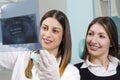 Female dentist holding x-ray, dental scan