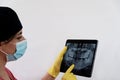 Female dentist inspecting the x-ray of the teeth of her patient