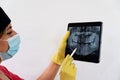 Female dentist inspecting the x-ray of the teeth of her patient