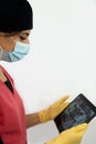 Female dentist inspecting the x-ray of the teeth of her patient