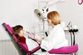 Female dentist and little girl patient