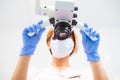 A female dentist is looking into a dental microsco Royalty Free Stock Photo