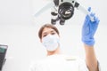 A female dentist is looking into a dental microsco Royalty Free Stock Photo