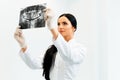 Female Dentist Looking at Dental Xray in Clinic