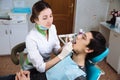 Female dentist with male patient at dental office. Concept of healthy