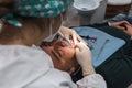 Female dentist with a patient in her office. Patient with open mouth and woman dentist working. dental health concept