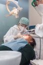 Female dentist with a patient in her office. Patient with open mouth and woman dentist working. dental health concept