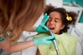 Female dentist patiently polish teeth to child Royalty Free Stock Photo