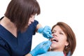 Female dentist performing oral exam