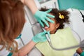 Female dentist polishing teeth to young girl Royalty Free Stock Photo