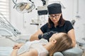 Female dentist preparing instrument for teeth treatment Royalty Free Stock Photo