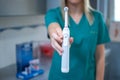 Female dentist's hand holding electric teethbrush at dental office. Royalty Free Stock Photo