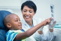 Female dentist showing boy his mouth x-ray Royalty Free Stock Photo