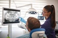 Dentist showing x-ray footage of teeth to patient