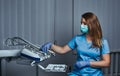 Female dentist sitting on a chair at his workplace in a dental clinic. Royalty Free Stock Photo