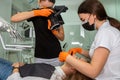 Female dentist with special camera with flash ring shadowless making shots of patients smile