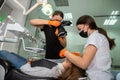 Female dentist with special camera with flash ring shadowless making shots of patients smile