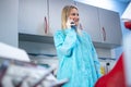 Female dentist talking on the phone at dental office. Royalty Free Stock Photo