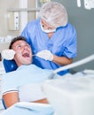 Female dentist treating male patient