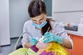 Female dentist treating teeth to patient, young woman in chair at dental clinic Royalty Free Stock Photo